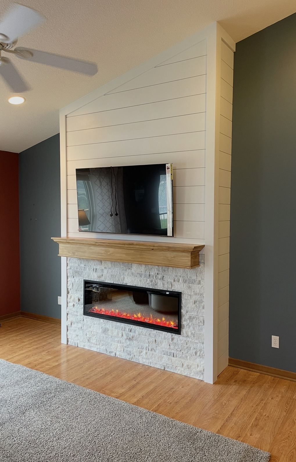 Custom fireplace wall with stone and wood mantel